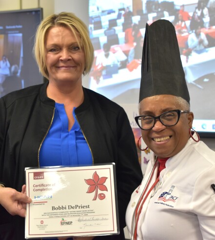 Woman holding certificate with Chef