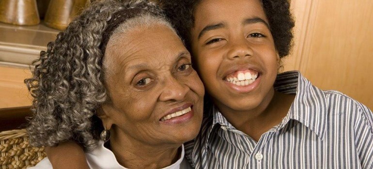 African-American grandmother hugging grandchild