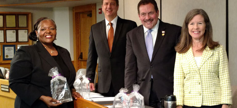 2 women and 2 men standing with awards smiling