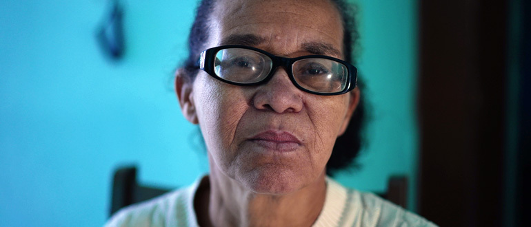 Woman with glasses looking at the camera