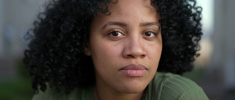 Woman looking solemnly at the camera