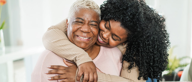a woman hugging an aging woman