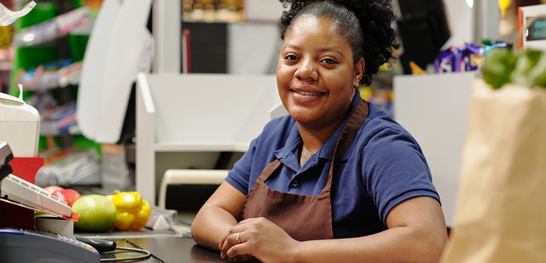 Woman employee leaning on a counter