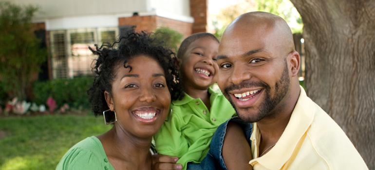 Three people smiling at the camera