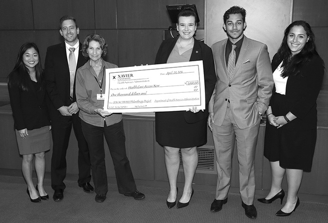 Six adults holding large check