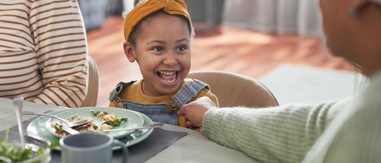 Girl smiling at a table