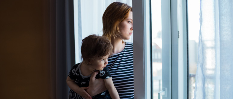Woman and child looking out a window