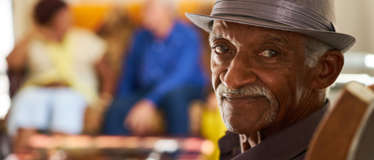 Man, smiling while looking at the camera