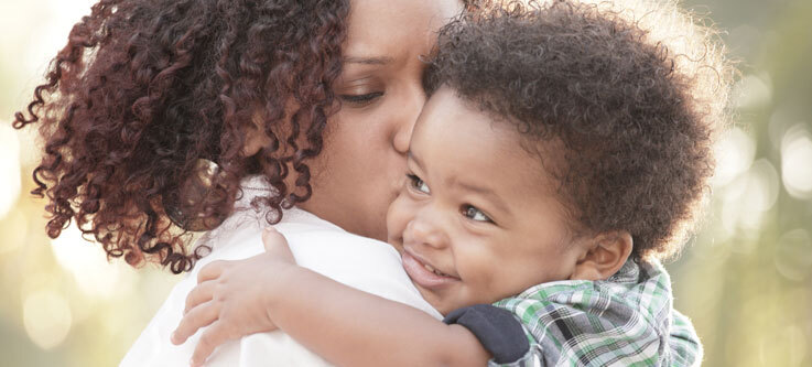 Woman kissing a baby