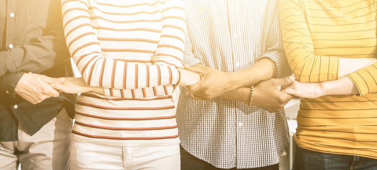 4 people linking hands
