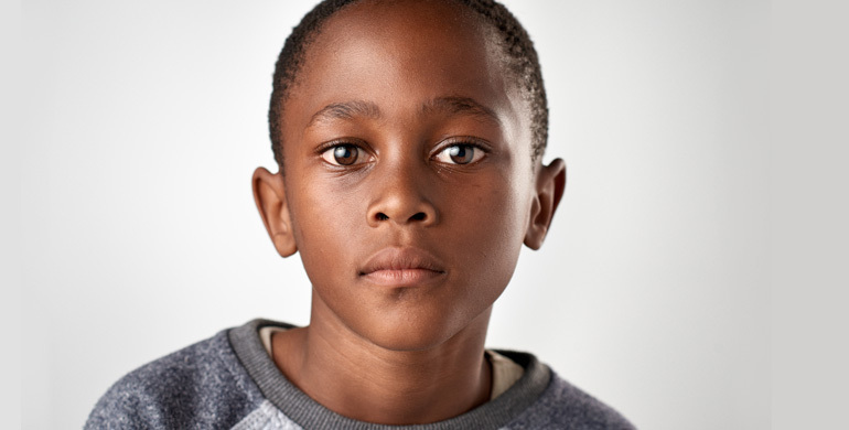 Child looking solemnly at the camera