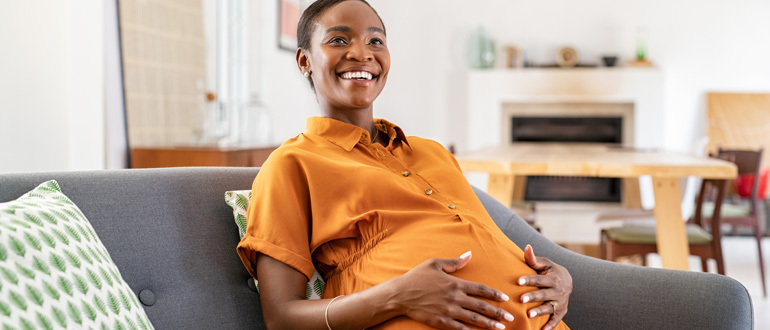 Pregnant woman sitting on a couch