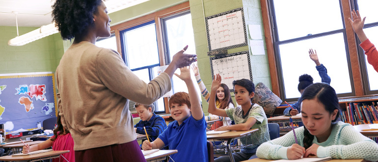 Teacher teaching children at school