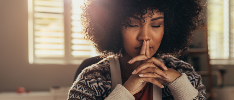 Woman sitting with eyes closed