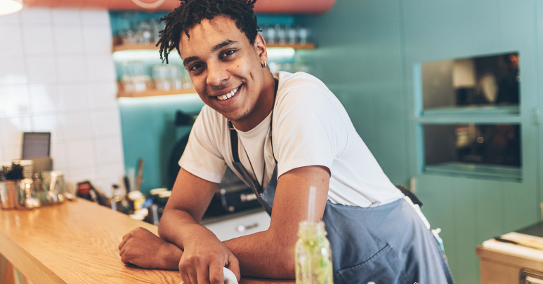 Man leaning on counter smiling