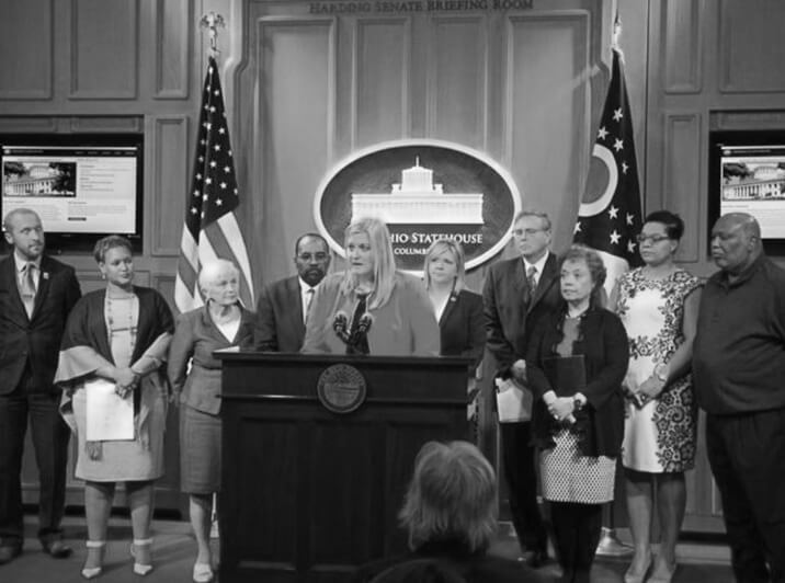Speaker at a podium at the statehouse