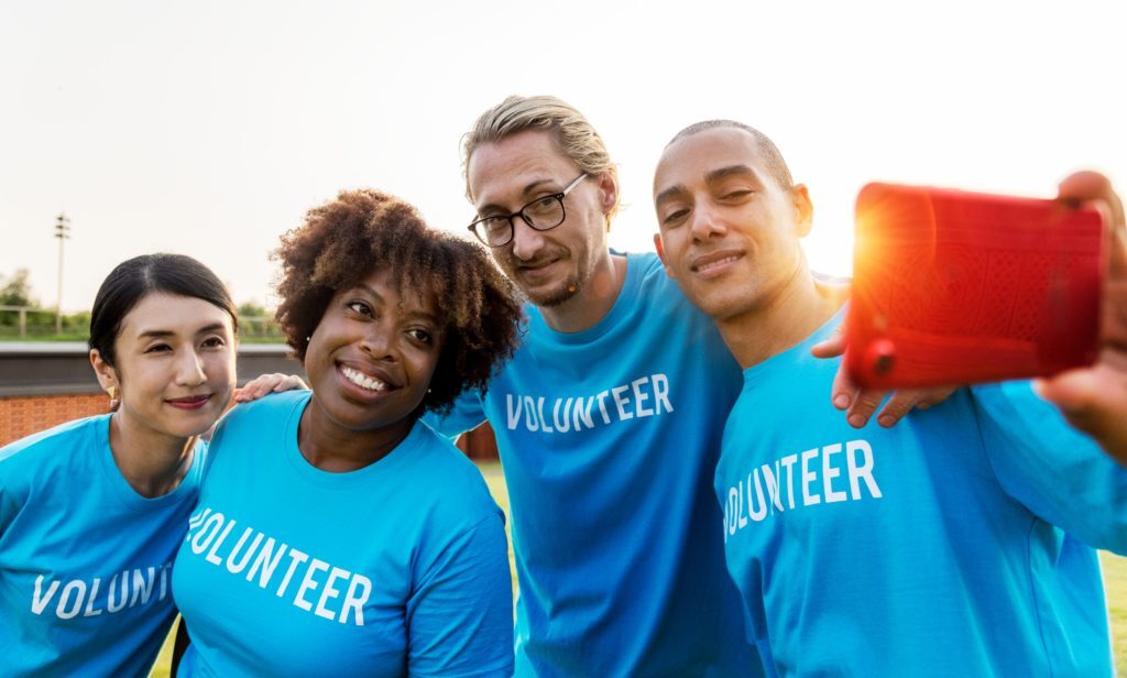a group of 4 volunteers taking a selfie